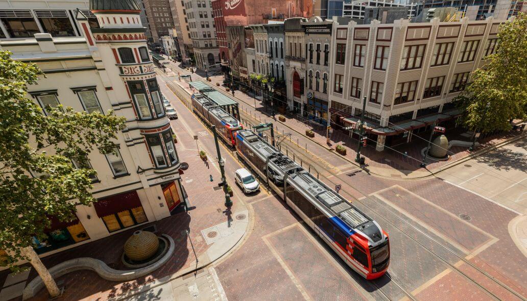 Aerial view of METRORail train traveling through a neighborhood in downtown Houston