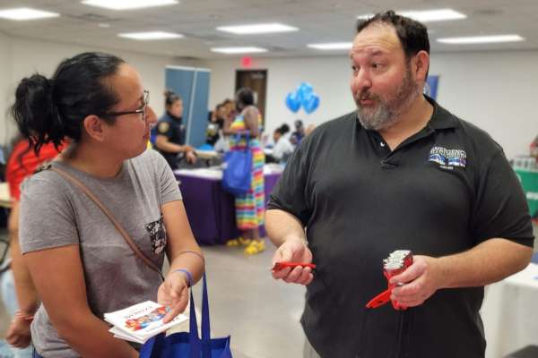 Richard Herrera speaks to a resident on the importance of emergency preparedness.
